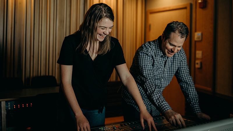 Student and instructor in sound production studio